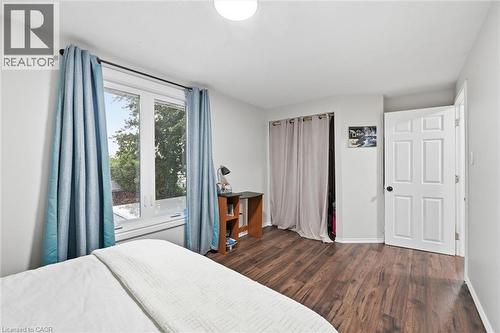 Room featuring wood-finish flooring, a double-paned window, and a paneled interior door - 450 East 42Nd Street, Hamilton, ON - Indoor Photo Showing Bedroom