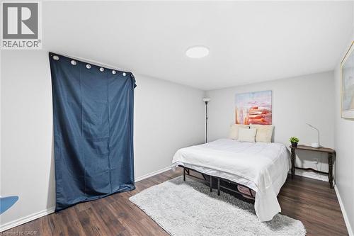 Spacious bedroom featuring wood-finish flooring, recessed ceiling lighting, and a platform bed frame - 450 East 42Nd Street, Hamilton, ON - Indoor Photo Showing Bedroom