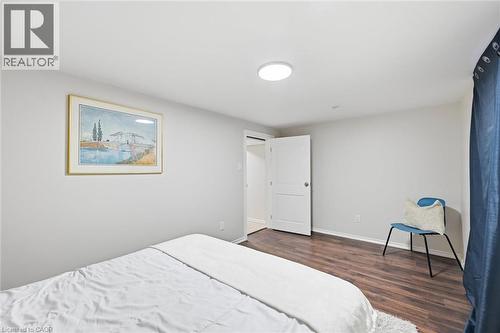 Interior room featuring wood-finish flooring, light-toned walls, and a ceiling-mounted flush light fixture - 450 East 42Nd Street, Hamilton, ON - Indoor Photo Showing Bedroom