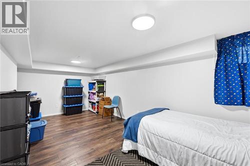 Spacious room featuring wood-finish flooring, recessed lighting, and a window with a blue valance - 450 East 42Nd Street, Hamilton, ON - Indoor Photo Showing Bedroom