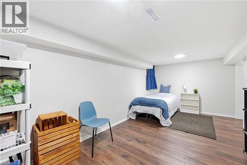 Spacious bedroom with wood-finish flooring, abundant natural light from multiple windows, and generous floor plan - 450 East 42Nd Street, Hamilton, ON - Indoor