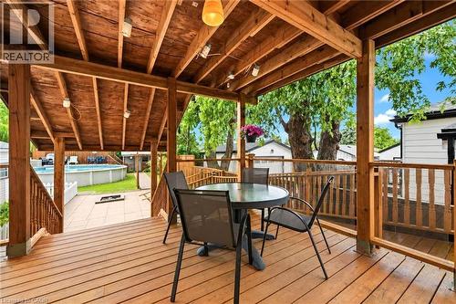 Expansive covered deck featuring wood-finish decking, exposed beam ceiling with recessed lighting, and sturdy wood railings - 450 East 42Nd Street, Hamilton, ON - Outdoor With Deck Patio Veranda With Exterior