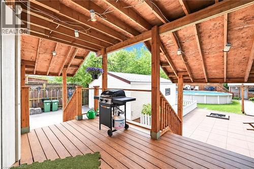 Expansive covered deck featuring exposed beam construction and wood-finish decking, anchored by a built-in grill station - 450 East 42Nd Street, Hamilton, ON - Outdoor With Deck Patio Veranda With Exterior