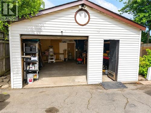 Detached garage featuring white horizontal siding and a brown-trimmed roofline - 450 East 42Nd Street, Hamilton, ON - Outdoor With Exterior