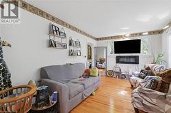 Hardwood flooring complements white walls and an accent border - 