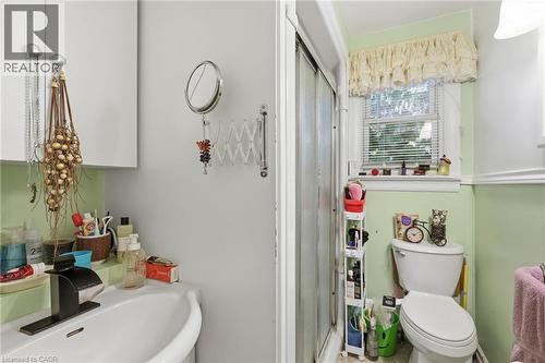 Bright and functional bathroom featuring dual vanity with white ceramic sink, soft green lower wall paneling, and ample storage - 356 Thompson Road, London, ON - Indoor Photo Showing Bathroom