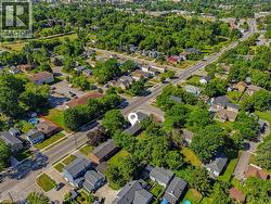 Aerial view showcasing this established residential neighborhood with mature tree canopy throughout - 