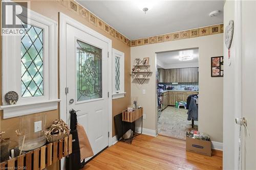 Welcoming entry foyer featuring hardwood flooring, decorative tile border detail, and white trim work throughout - 356 Thompson Road, London, ON - Indoor Photo Showing Other Room