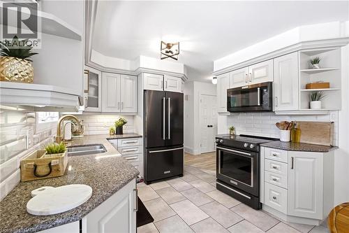including a refrigerator, range, and microwave - 581 Glendene Crescent, Waterloo, ON - Indoor Photo Showing Kitchen With Double Sink With Upgraded Kitchen