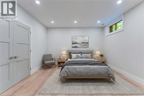 Bedroom featuring light wood-finish flooring, recessed lighting, and a horizontal window - 986 Highway 8, Hamilton, ON - Indoor Photo Showing Bedroom
