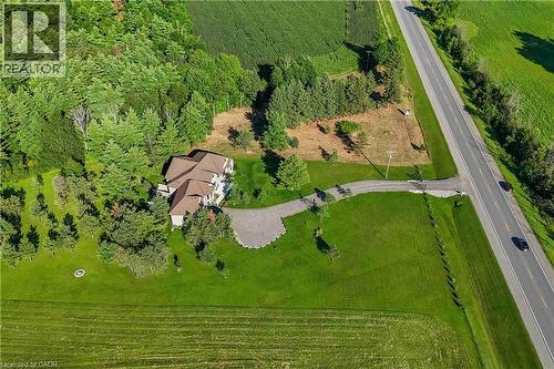 Expansive property featuring a multi-gabled residence with a brown shingle roof, surrounded by mature trees and manicured lawns - 986 Highway 8, Hamilton, ON - Outdoor With View