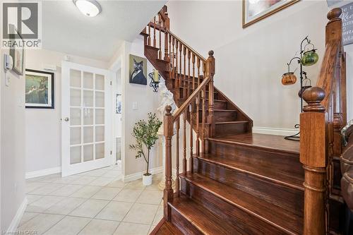Rich wood-finish staircase featuring a full baluster railing system - 86 Bridlewreath Street, Kitchener, ON - Indoor Photo Showing Other Room