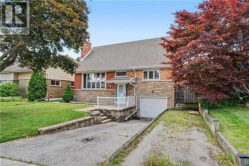 Brick and stone-clad residence featuring a single-car garage and a paved driveway - 100 Hardale Crescent, Hamilton, ON - Outdoor