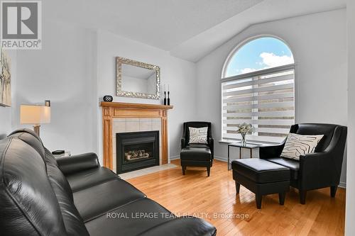 Family room with gas FP and large arched window - 4121 Wolfe Point Way, Ottawa, ON - Indoor Photo Showing Living Room With Fireplace