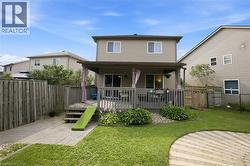 Spacious two-story home with a welcoming covered front porch featuring railings and entry steps - 