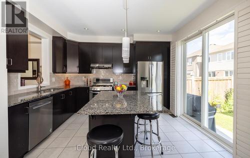 Upgraded Light Fixtures & Pot Lights - 954 Penson Crescent, Milton, ON - Indoor Photo Showing Kitchen With Stainless Steel Kitchen With Double Sink With Upgraded Kitchen
