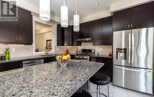 Eat-In Kitchen Overlooks Dining Room - 954 Penson Crescent, Milton, ON - Indoor Photo Showing Kitchen With Stainless Steel Kitchen With Double Sink With Upgraded Kitchen