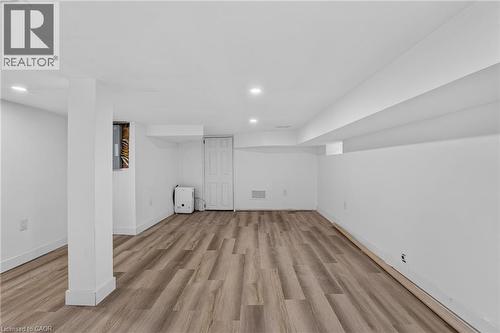 Open room featuring wood-finish flooring, recessed lighting, and white painted walls - 325 Queensdale Avenue E, Hamilton, ON - Indoor Photo Showing Other Room
