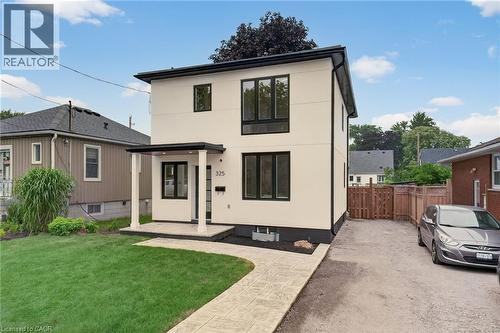 Contemporary two-story exterior with light-colored siding and dark trim - 325 Queensdale Avenue E, Hamilton, ON - Outdoor
