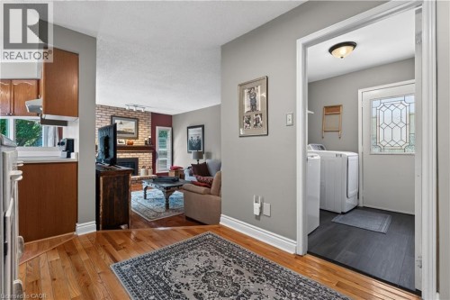 View from main floor hallway to laundry room, family room, and kitchen - 3194 Tania Crescent, Burlington, ON - Indoor Photo Showing Laundry Room