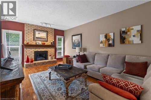 Main floor family room with fireplace, patio door to back deck - 3194 Tania Crescent, Burlington, ON - Indoor Photo Showing Living Room With Fireplace
