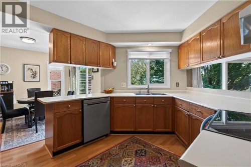 Kitchen has a pass-thru to the family room - 3194 Tania Crescent, Burlington, ON - Indoor Photo Showing Kitchen With Double Sink