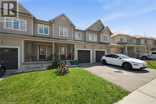 Exterior facade featuring light-colored siding, multiple windows, and covered front porches with stone accents - 32 Cole Crescent, Brantford, ON - Outdoor With Facade