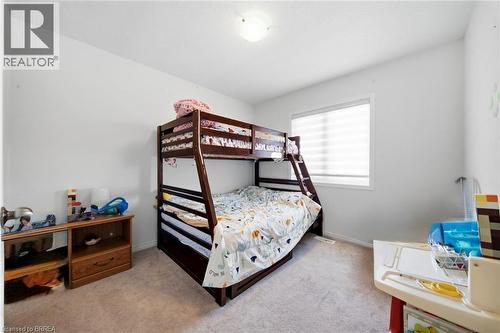 Carpeted room featuring a single window with blinds, white walls, and a ceiling-mounted light fixture - 32 Cole Crescent, Brantford, ON - Indoor Photo Showing Bedroom