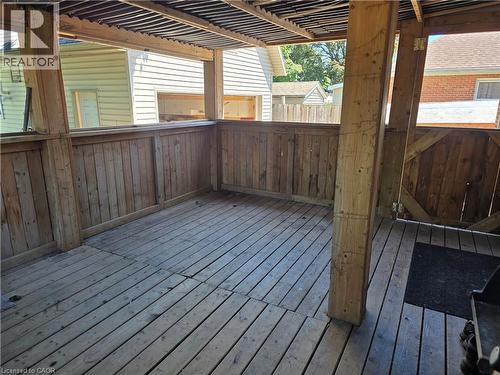 Covered wood deck with slatted wood flooring, wood post and rail construction, and a corrugated roof - 76 Brentwood Avenue, Kitchener, ON - Outdoor With Deck Patio Veranda With Exterior