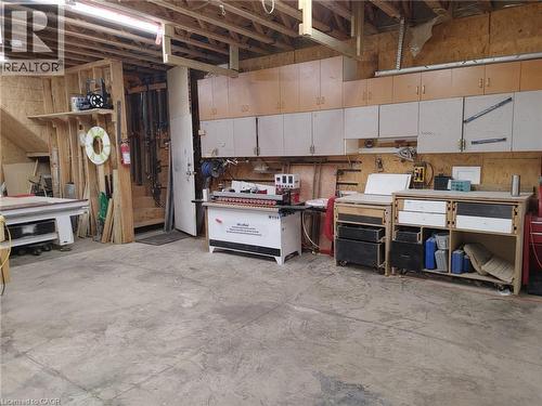 Spacious workshop area featuring exposed ceiling joists and concrete flooring - 76 Brentwood Avenue, Kitchener, ON - Indoor Photo Showing Basement