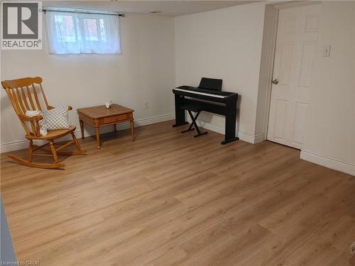 Light-toned wood-finish flooring, white painted walls, and a white paneled door - 76 Brentwood Avenue, Kitchener, ON - Indoor Photo Showing Other Room