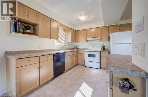 Kitchen featuring light wood cabinetry, a white electric range, a white refrigerator, a black dishwasher, and a double basin sink - 496 Langlaw Drive, Cambridge, ON - Indoor Photo Showing Kitchen