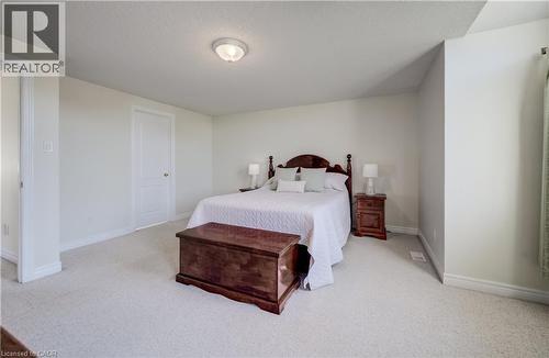 Spacious primary bedroom with wood-finish flooring, recessed ceiling lighting, and ample natural light - 496 Langlaw Drive, Cambridge, ON - Indoor Photo Showing Bedroom