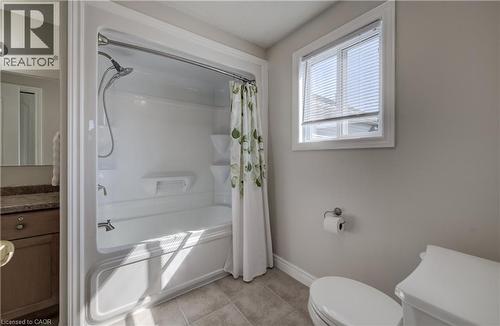 White bathtub and shower combination unit featuring a chrome showerhead and faucet - 496 Langlaw Drive, Cambridge, ON - Indoor Photo Showing Bathroom