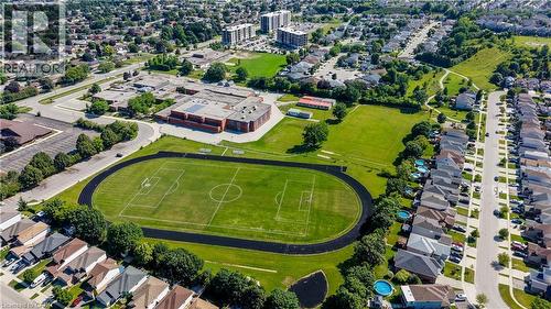 Residential neighborhood featuring a multi-building educational facility with an athletic field and track - 496 Langlaw Drive, Cambridge, ON - Outdoor With View