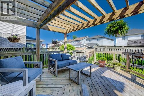 Expansive wood-finish deck with a large wooden pergola, perimeter fencing, and a decorative railing - 496 Langlaw Drive, Cambridge, ON - Outdoor With Deck Patio Veranda With Exterior