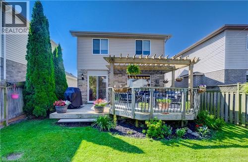 Expansive backyard featuring a multi-level wood deck, an integrated pergola, and a grassy lawn - 496 Langlaw Drive, Cambridge, ON - Outdoor With Deck Patio Veranda