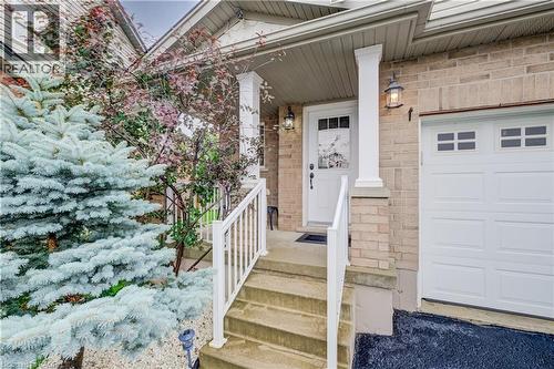 Brick exterior with a covered porch entry - 521 Snowdrop Court, Kitchener, ON - Outdoor
