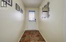 Entryway featuring a white door with integrated blinds, square multi-tone floor tiles, and neutral-toned walls - 521 Snowdrop Court, Kitchener, ON  - Indoor Photo Showing Other Room 