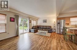 Open-concept living space with wood-finish flooring - 