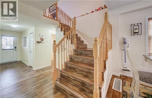 Staircase featuring wood-finish treads and natural wood balusters - 521 Snowdrop Court, Kitchener, ON - Indoor Photo Showing Other Room