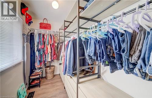 Customizable closet system with wood-finish flooring - 521 Snowdrop Court, Kitchener, ON - Indoor With Storage