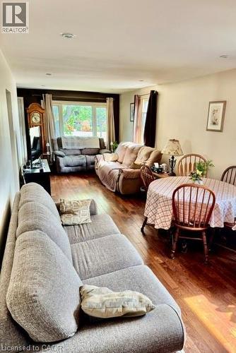 Open-concept living area featuring rich wood-finish flooring, recessed lighting, and ample natural light from multiple windows - 342 Barton Street, Hamilton, ON - Indoor Photo Showing Living Room