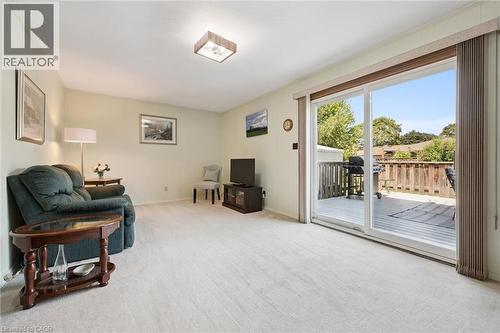 Spacious family room bathed in natural light from expansive sliding glass doors that open to a private deck - 18 Strathcona Crescent, Kitchener, ON - Indoor
