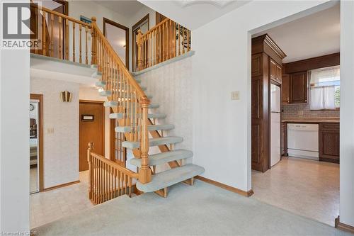 Two-story foyer featuring a carpeted staircase with wood railings and balusters - 18 Strathcona Crescent, Kitchener, ON - Indoor Photo Showing Other Room