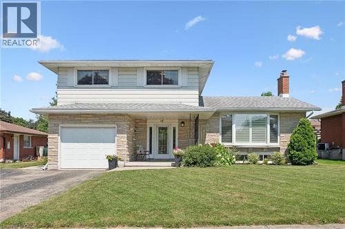 Split-level residence featuring a stone-clad facade, attached single-car garage, and a gabled roofline - 18 Strathcona Crescent, Kitchener, ON - Outdoor With Facade