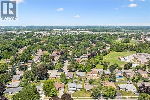 Aerial view showcasing a tree-lined residential neighborhood with mature landscaping, spacious lot sizes, and low-density suburban character - 18 Strathcona Crescent, Kitchener, ON - Outdoor With View