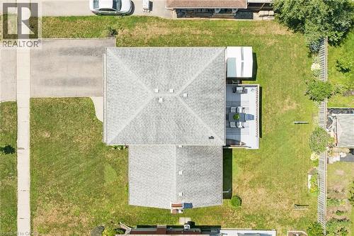 Expansive backyard featuring a large deck, mature trees, and a substantial storage shed - 18 Strathcona Crescent, Kitchener, ON - 