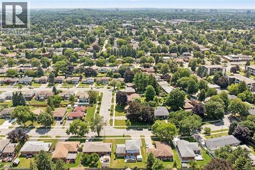 Established residential neighborhood featuring tree-lined streets, single-family homes with varied architectural styles, and mature landscaping throughout - 18 Strathcona Crescent, Kitchener, ON - Outdoor With View