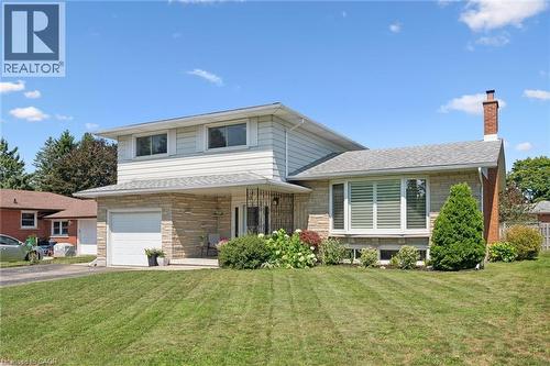 Featuring a stone and siding exterior - 18 Strathcona Crescent, Kitchener, ON - Outdoor With Facade